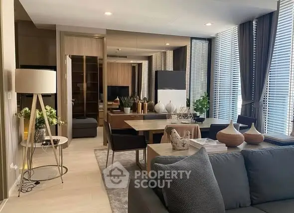 Modern living room with stylish decor and large windows for natural light.