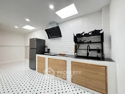 Modern kitchen with sleek cabinets and stylish backsplash in a spacious layout.