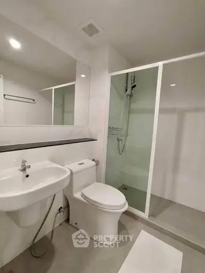 Modern bathroom with glass shower and sleek fixtures