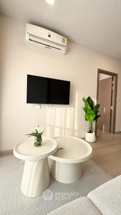 Modern living room with sleek furniture and wall-mounted TV