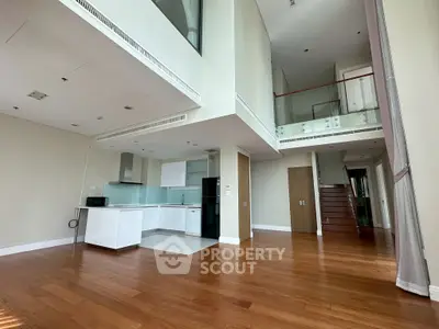 Spacious modern living room with open kitchen and high ceilings