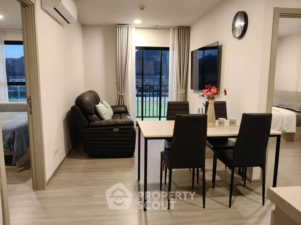 Modern living room with dining area and balcony access in stylish apartment