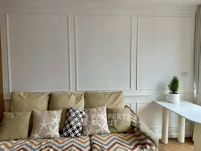 Chic living room with stylish sofa and modern decor, perfect for cozy relaxation.