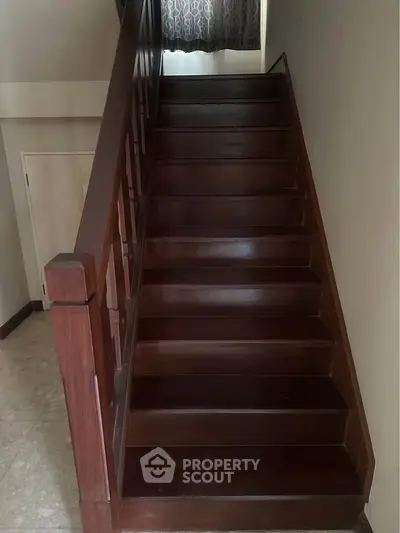 Elegant wooden staircase with rich finish in a modern home interior