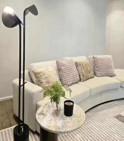 Stylish living room with modern curved sofa and elegant floor lamp