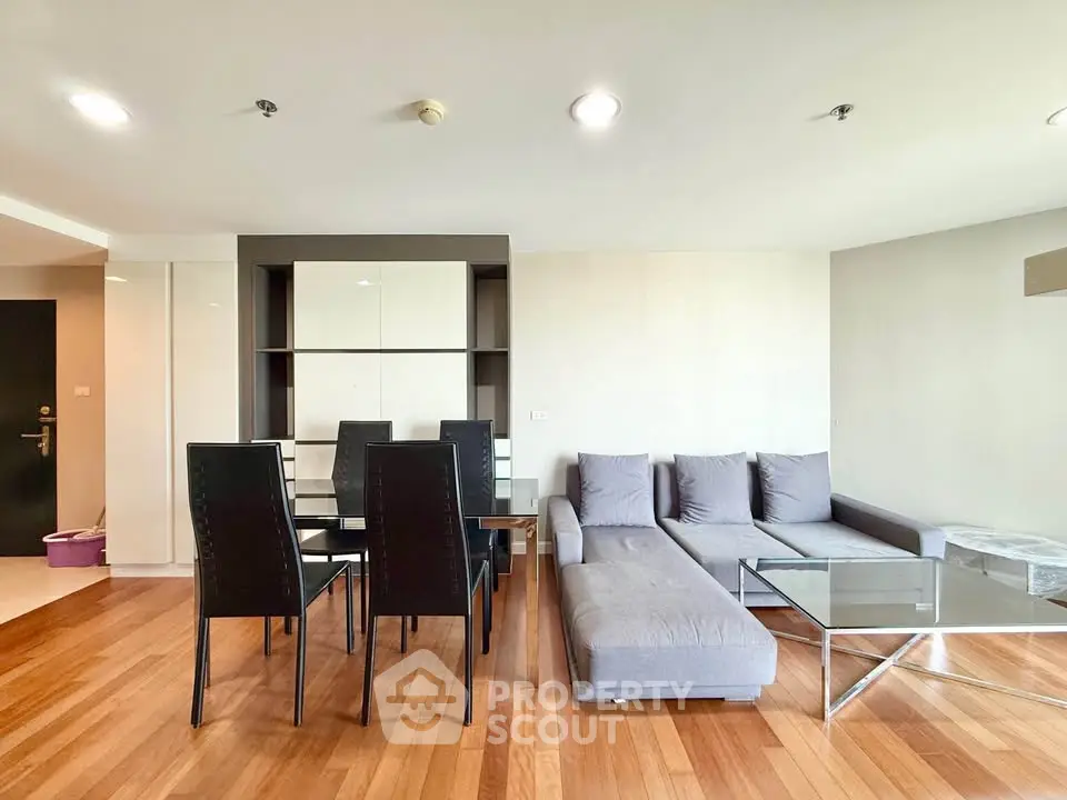 Spacious modern living room with sleek furniture and wooden flooring