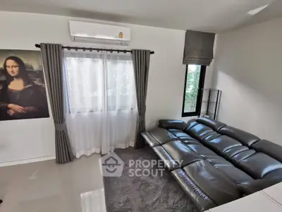 Modern living room with sleek leather sofa and elegant curtains