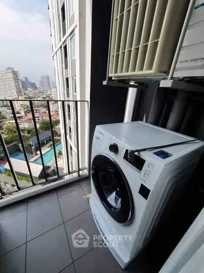 Modern balcony with washing machine and city view in high-rise apartment