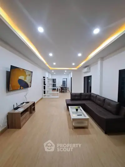 Spacious modern living room with sleek design and ambient lighting