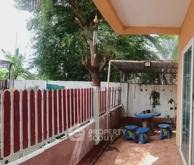 Charming outdoor patio with colorful seating and lush greenery, perfect for relaxation and entertaining.