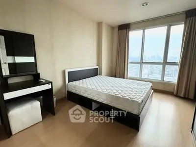 Spacious bedroom with city view and modern furnishings
