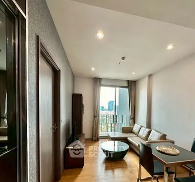 Modern living room with city view, featuring sleek furniture and natural light.