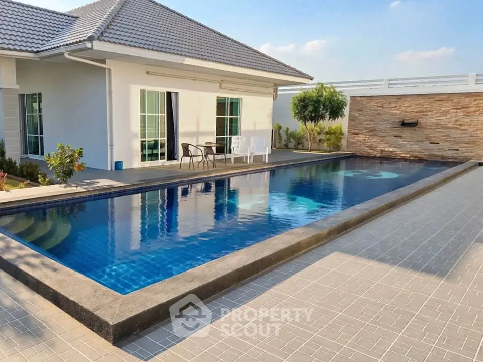 Modern house with a sleek swimming pool and stylish patio area, perfect for relaxation and entertainment.