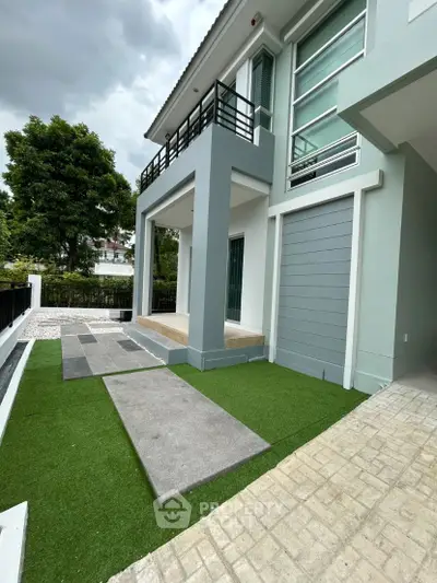 Modern two-story house with sleek design and lush green lawn
