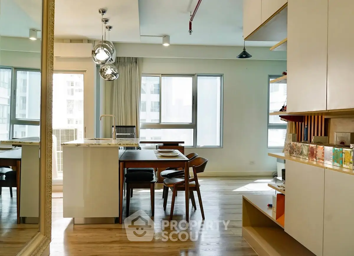 Modern dining area with stylish decor and ample natural light in a contemporary apartment.