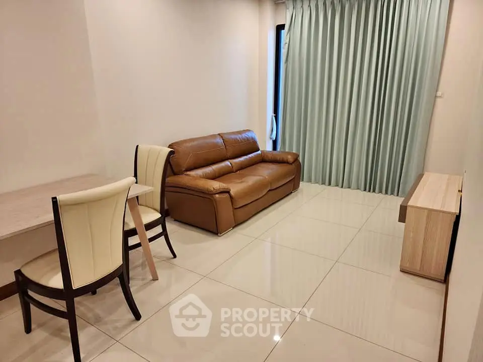 Modern living room with leather sofa and elegant dining set