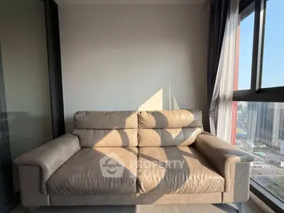 Cozy balcony with plush sofa and city view, perfect for relaxation.