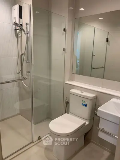 Modern bathroom with glass shower enclosure and sleek fixtures