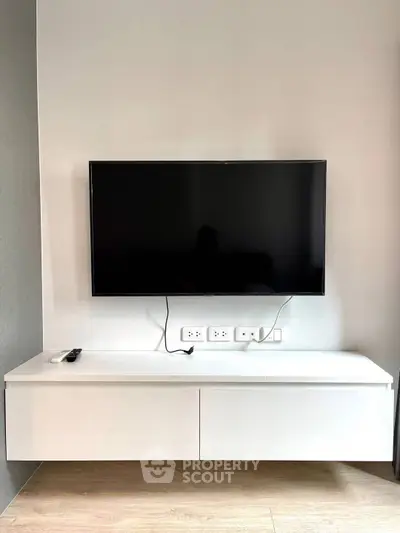 Modern living room with wall-mounted TV and sleek console table