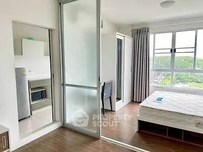 Bright bedroom with sliding glass door and scenic window view