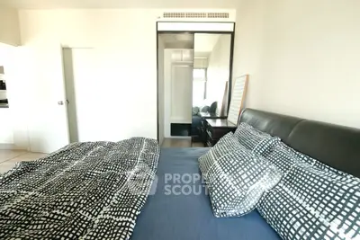 Spacious bedroom with modern decor and large mirror closet doors