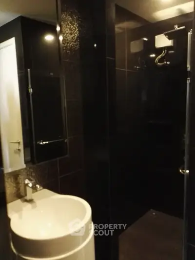 Modern bathroom with sleek black tiles and stylish fixtures