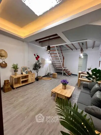 Spacious living room with modern decor and wooden staircase, perfect for stylish urban living.