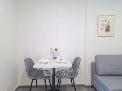 Cozy dining nook with modern chairs and a small table in a stylish apartment.