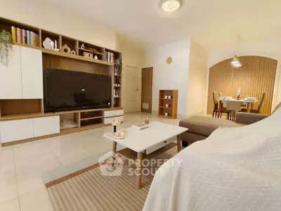 Spacious modern living room with stylish furniture and dining area, perfect for family gatherings.