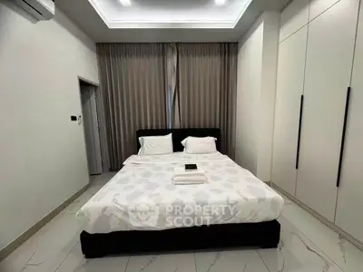 Modern bedroom with sleek design and ample storage space