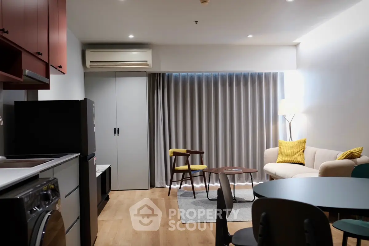 Modern living room with stylish furniture and open kitchen layout, perfect for urban living.