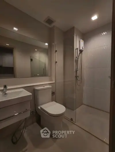 Modern bathroom with sleek fixtures and glass shower enclosure