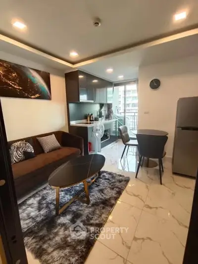 Modern living room with open kitchen and balcony view in stylish apartment.