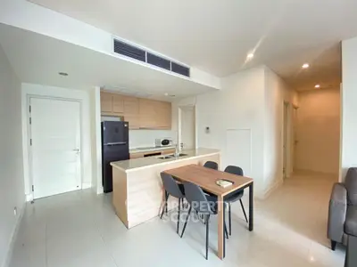 Modern open-layout kitchen and dining area with sleek design and neutral tones.
