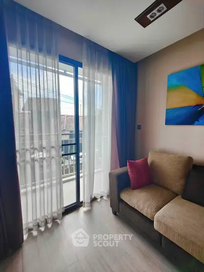 Cozy living room with modern decor and balcony access