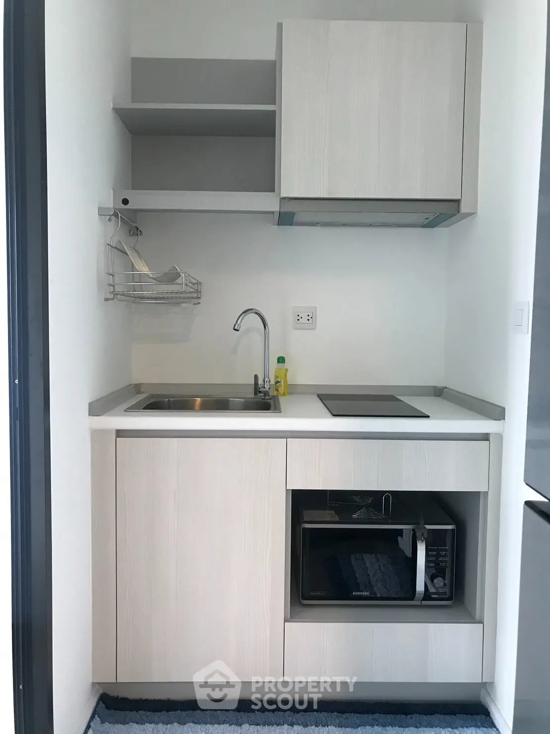 Compact modern kitchen with sleek cabinetry and built-in appliances in a minimalist design.