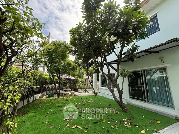 Charming garden view with lush greenery and modern house exterior