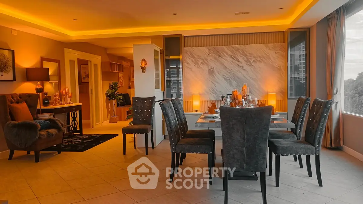 Luxurious open-plan living and dining area with elegant lighting and modern decor.