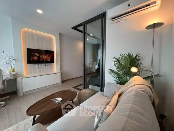 Modern living room with sleek design, featuring a cozy sofa, wall-mounted TV, and stylish decor.