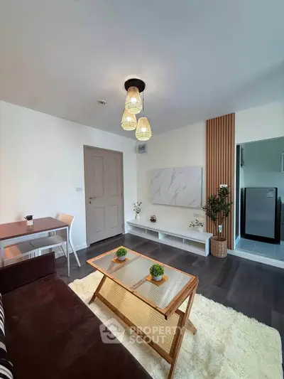 Modern living room with stylish decor and natural light, featuring a cozy seating area and elegant lighting.