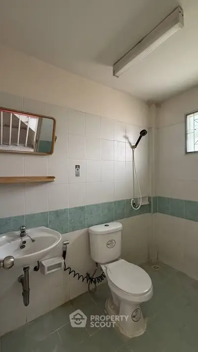 Compact bathroom with shower and toilet in minimalist design