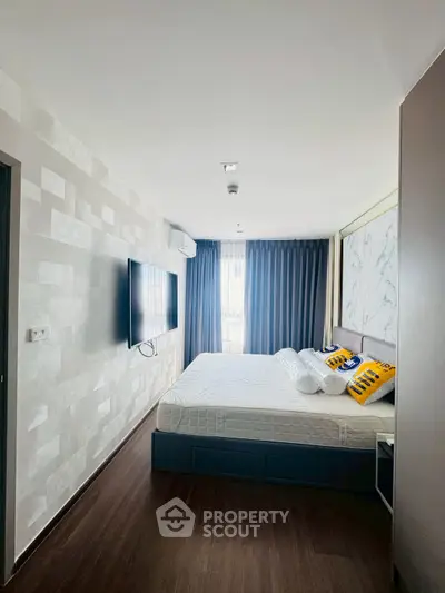 Modern bedroom with wall-mounted TV and stylish decor