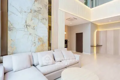 Luxurious modern living room with high ceilings and elegant marble accent wall