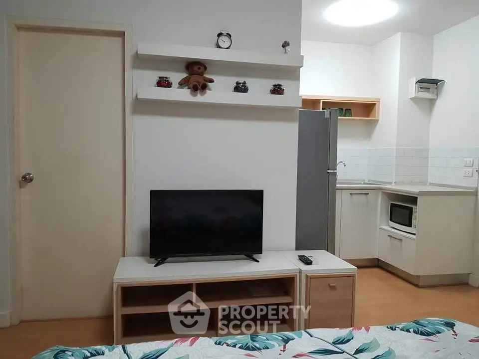 Cozy studio apartment with modern kitchen and stylish decor, perfect for urban living.
