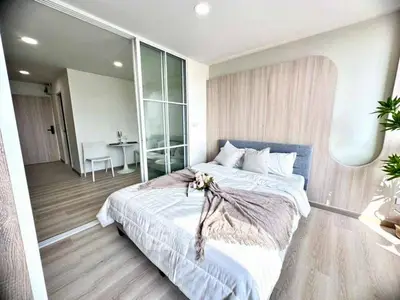 Modern bedroom with stylish decor and natural light in a contemporary apartment.