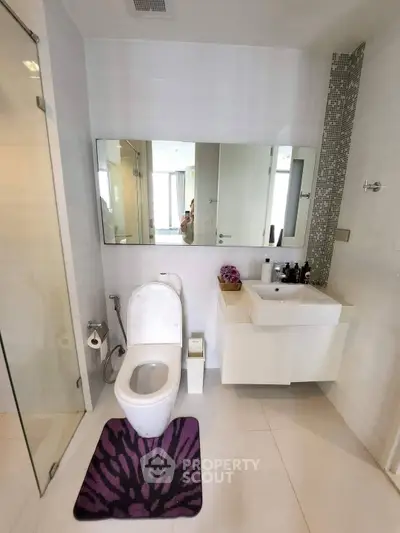 Modern bathroom with sleek fixtures and stylish decor in a contemporary apartment.