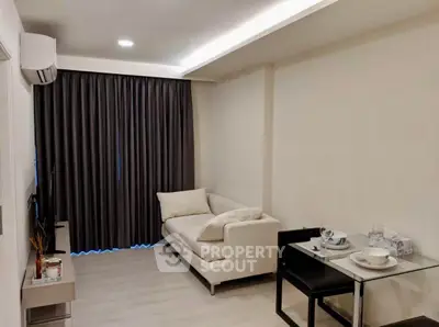 Modern living room with cozy sofa and dining area in a stylish apartment.
