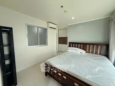 Spacious bedroom with modern furnishings and natural light, perfect for comfortable living.