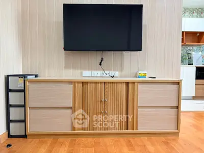 Modern living room with mounted TV and stylish wooden cabinet