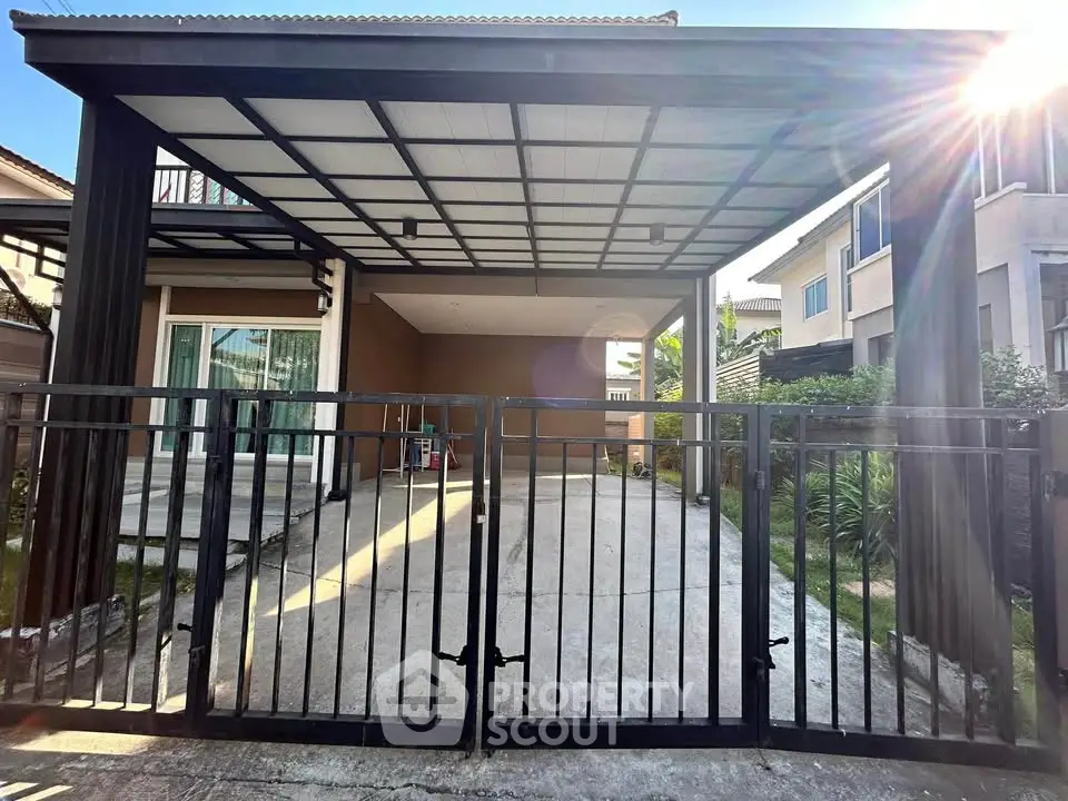 Modern house with spacious driveway and sleek metal gate